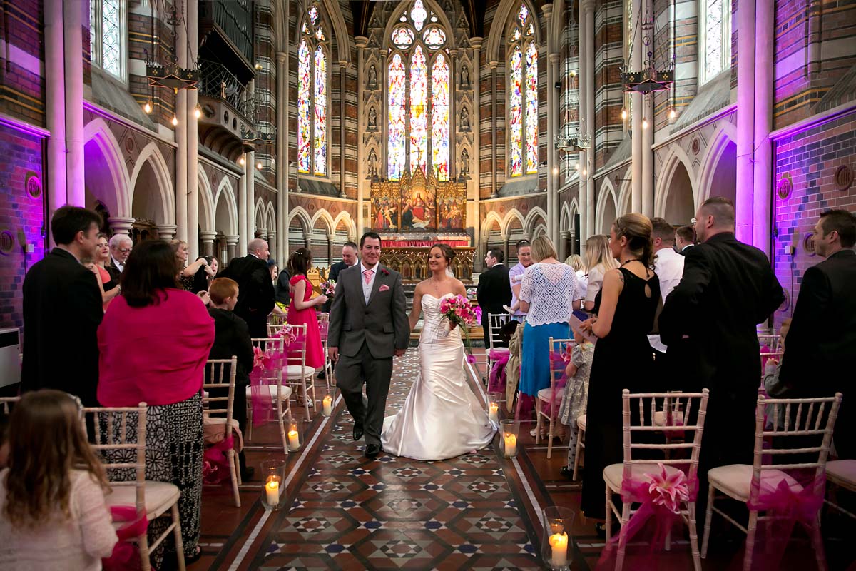 bride and groom walking together down the isle