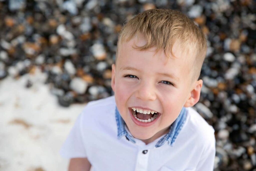 Eastbourne_family_photographer_beach_powell-ful_photography.2 Eastbourne photography young boy on the beach smiling to the camera