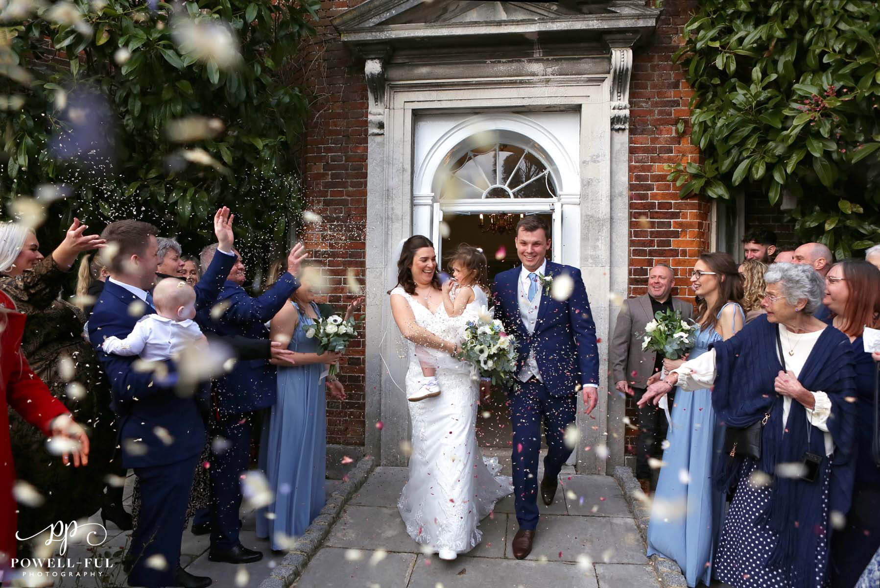 bride and groom having confetti thrown on them