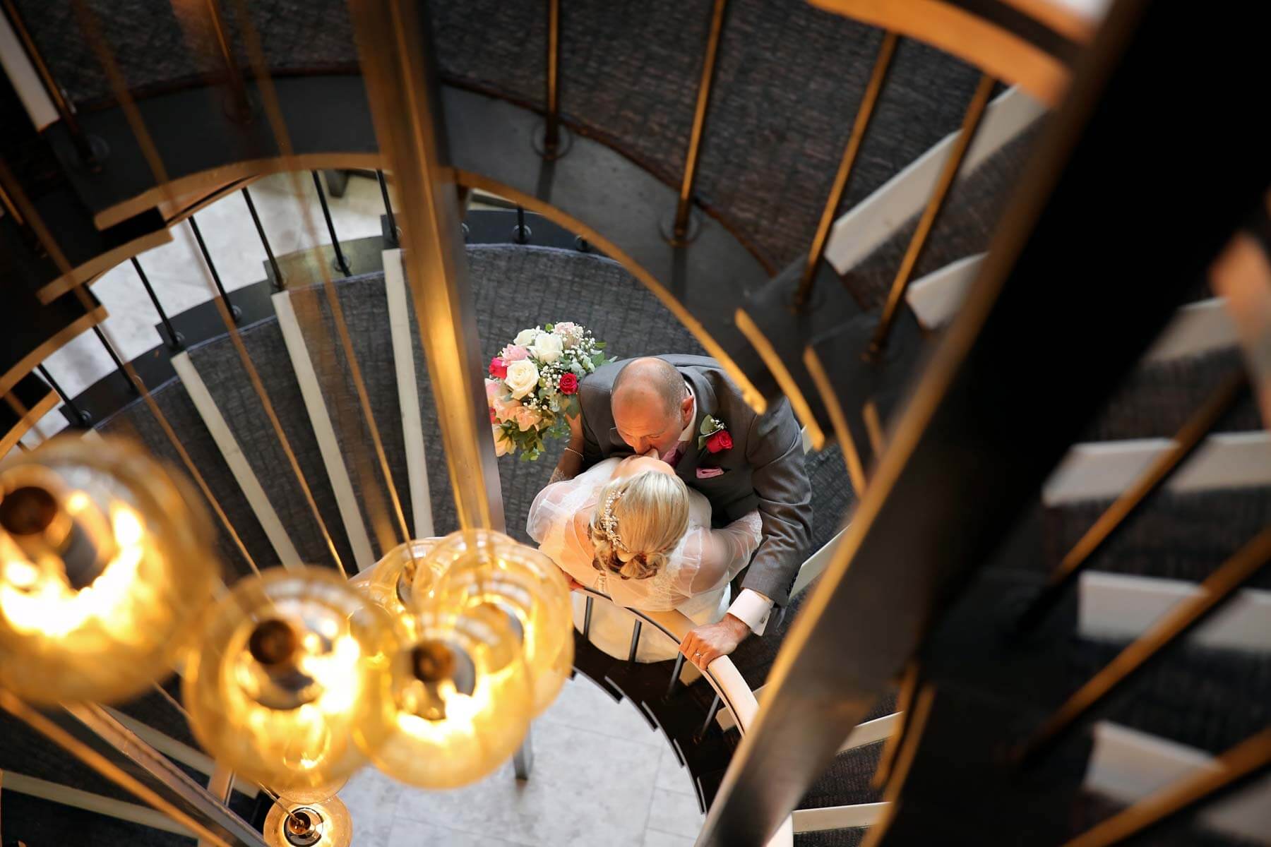 the view hotel bride and groom kissing on stairs
