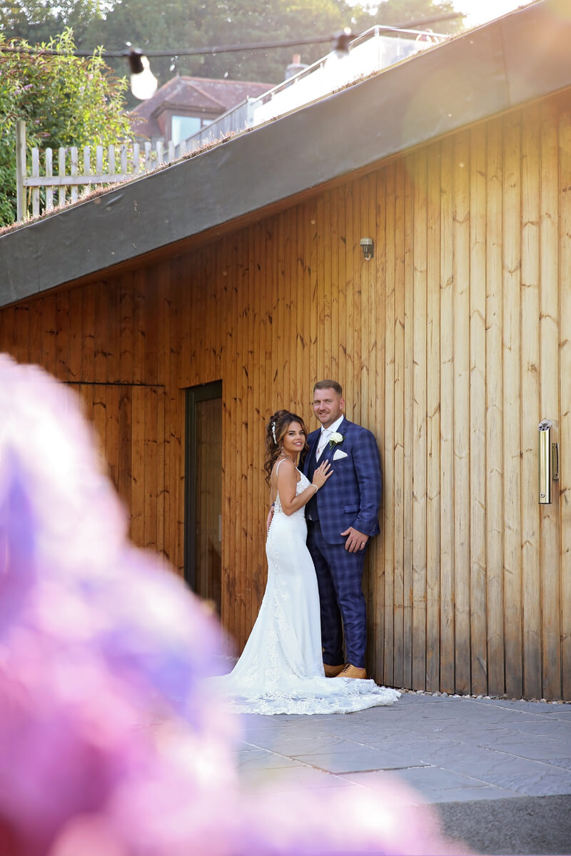 bride and groom looking into the camera outside