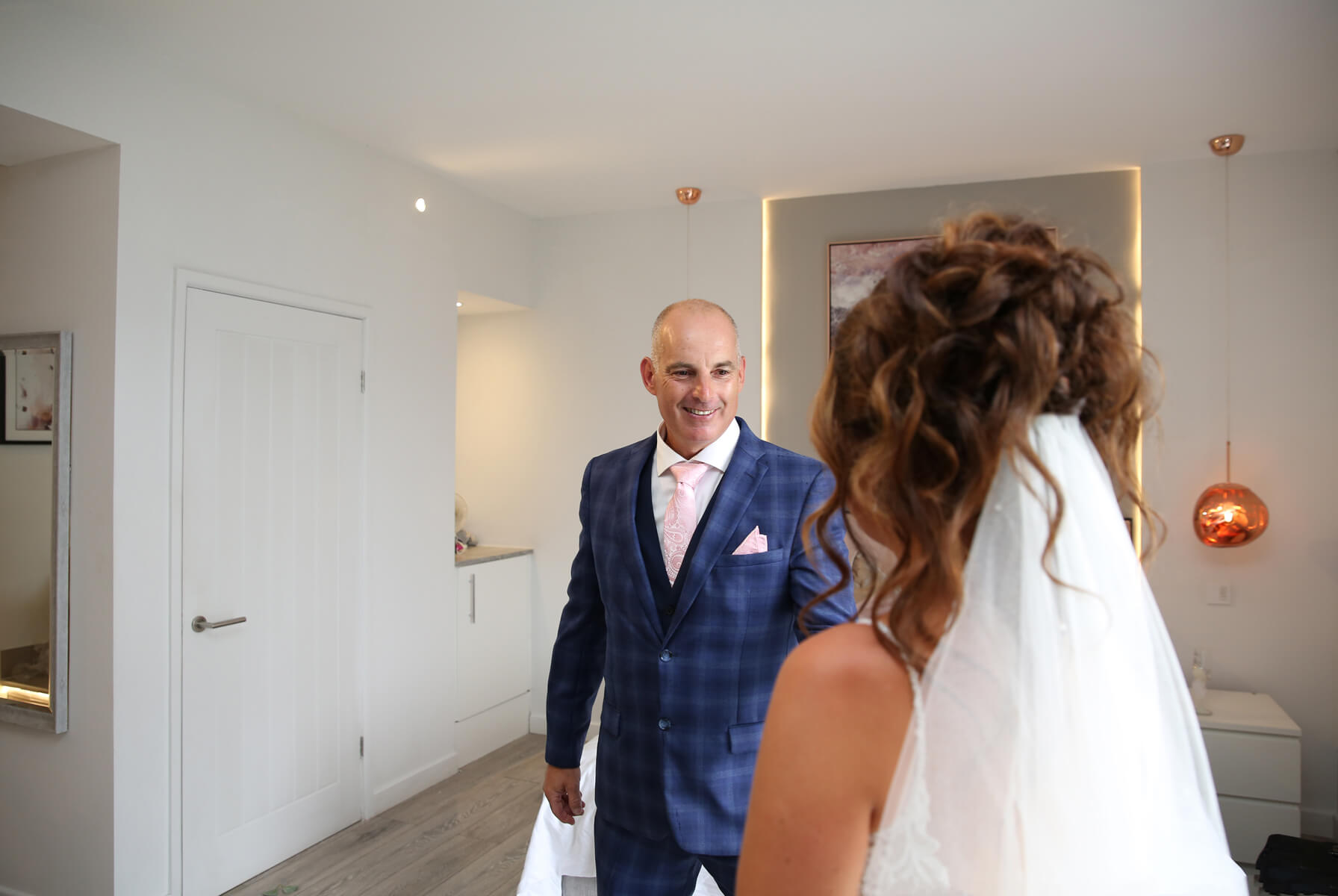 dad seeing his daughter in her wedding dress