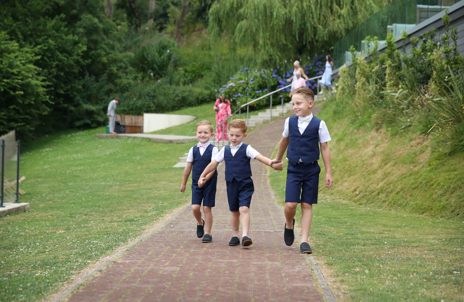 three boys walking up the isle