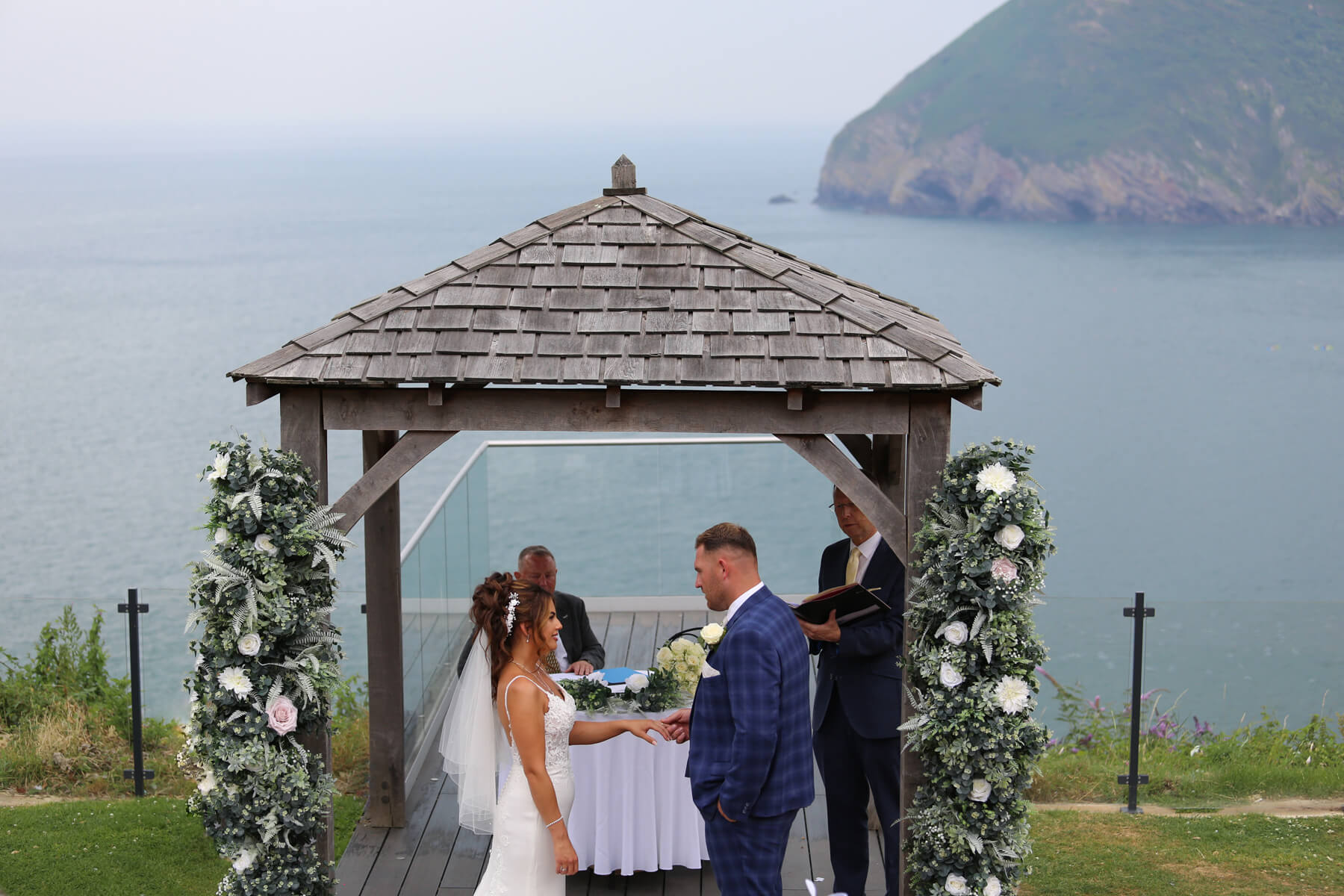bride and groom at there ceremony with a sea view