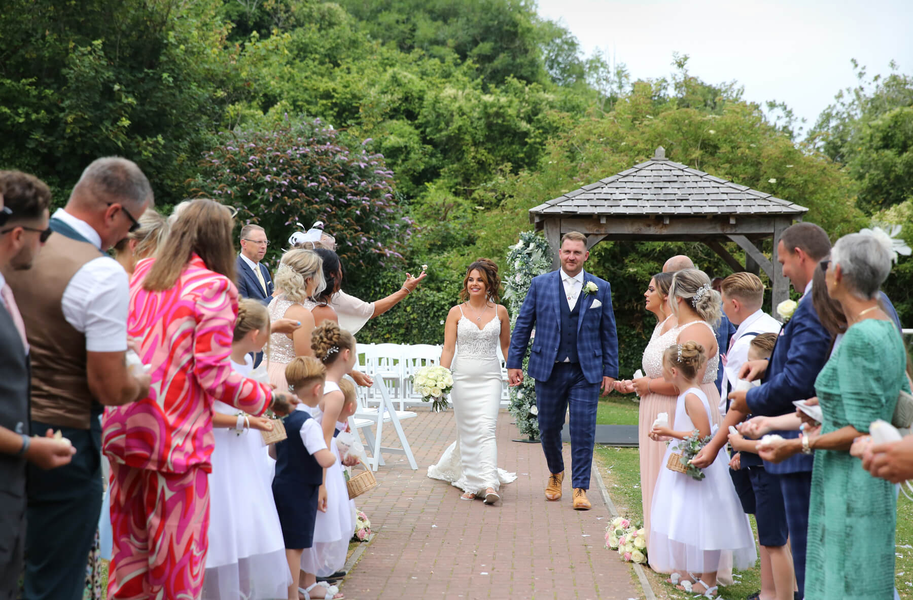 bride and grooms walking through confetti