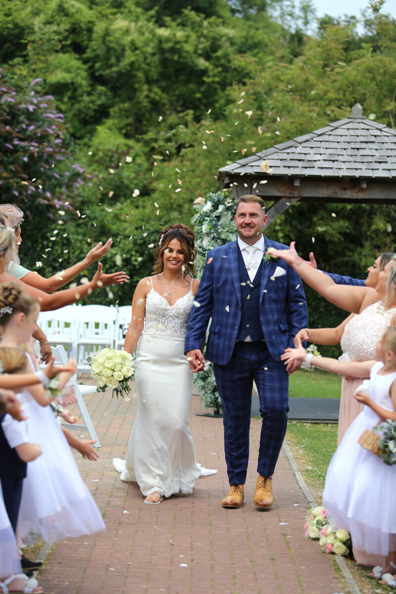 grooms having walking through confetti