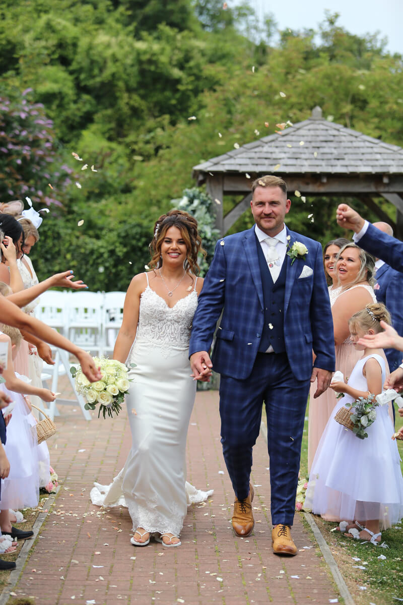 grooms having walking through confetti