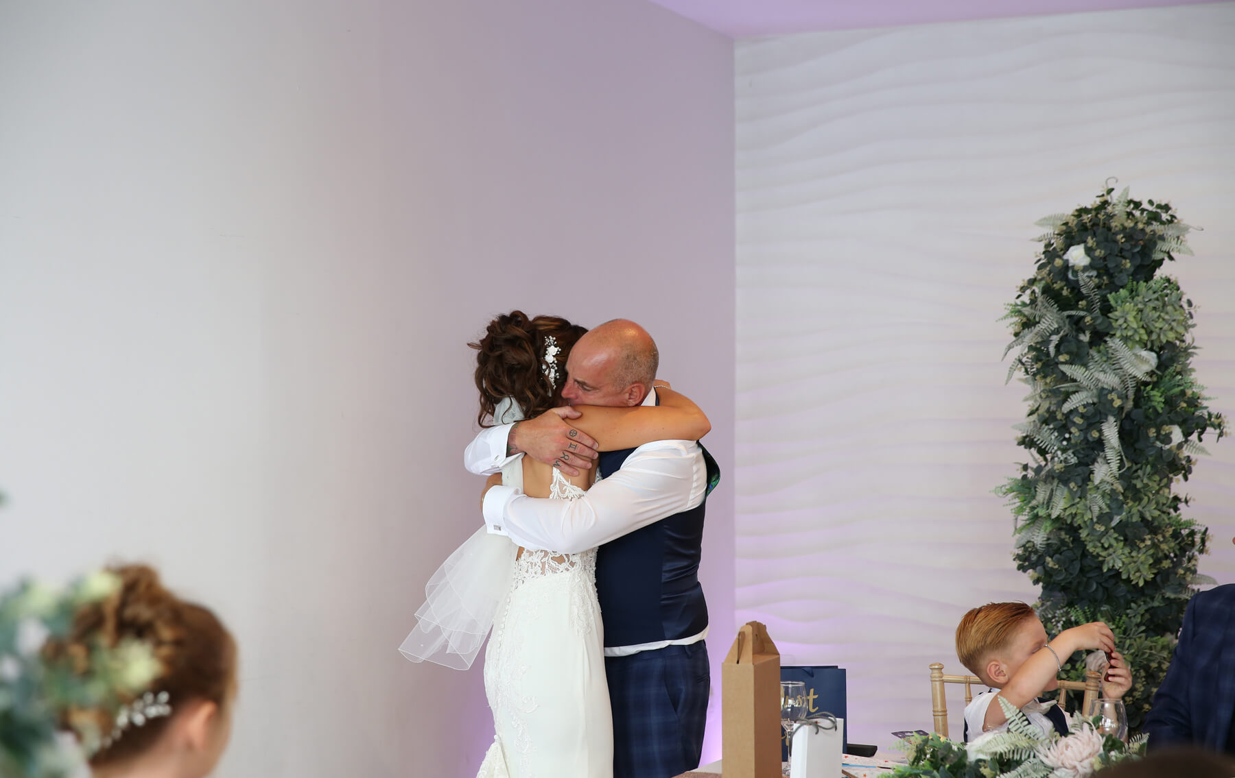 bride and father of the bride cuddling