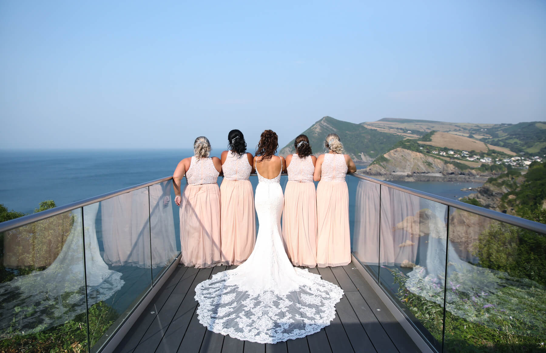 bride and bridesmaid looking out to sea