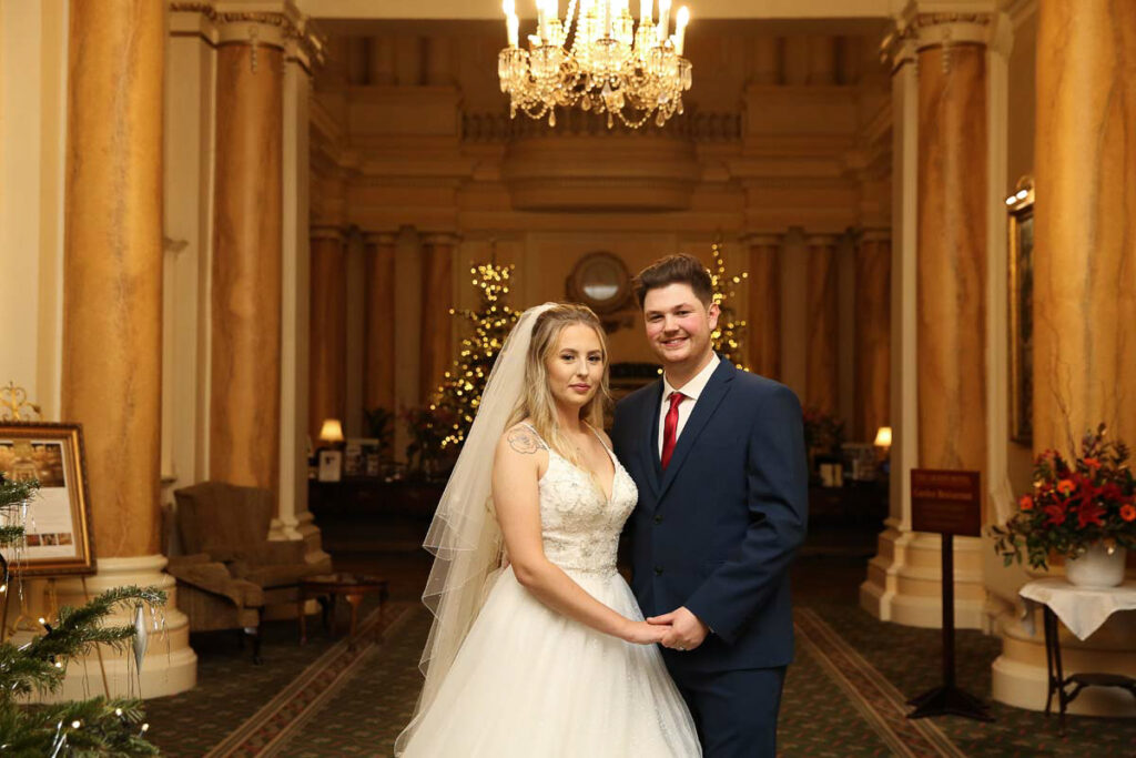 Eastbourne_wedding_photographer_the_grand_hotel_powell-ful_photography bride and groom in front of a mirror at The Grand Hotel Eastbourne