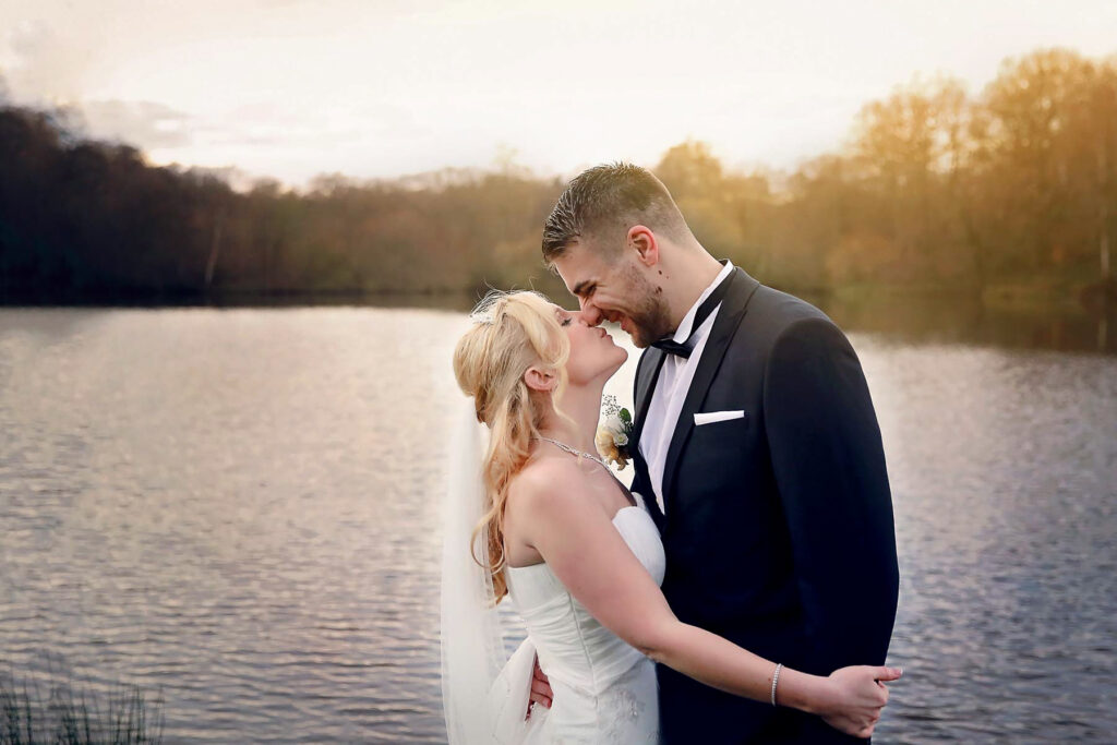 bride and groom by a lake at The Powdermills Hotel