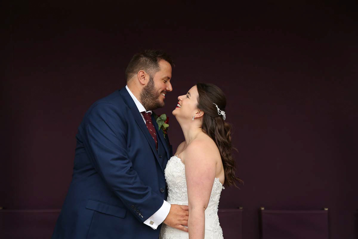 bride and groom looking at each other smiling