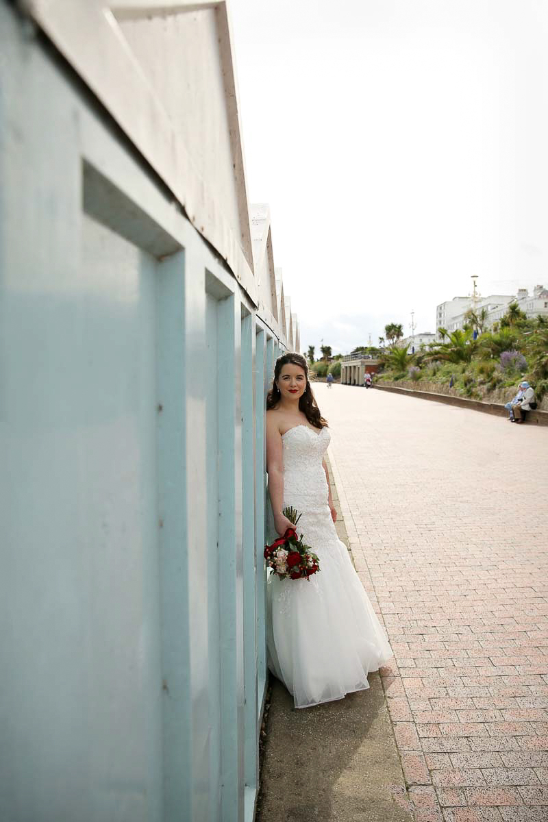 bride leaning against a wall