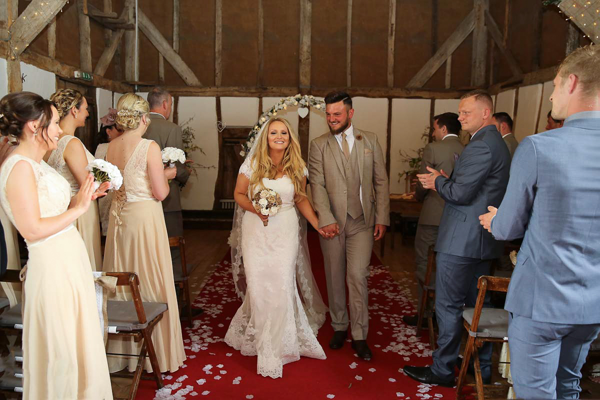 bride and groom walking down the isle