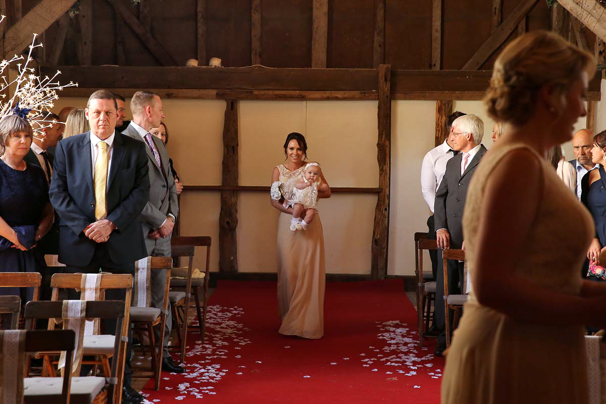 bridesmaid hold baby, walking up the isle