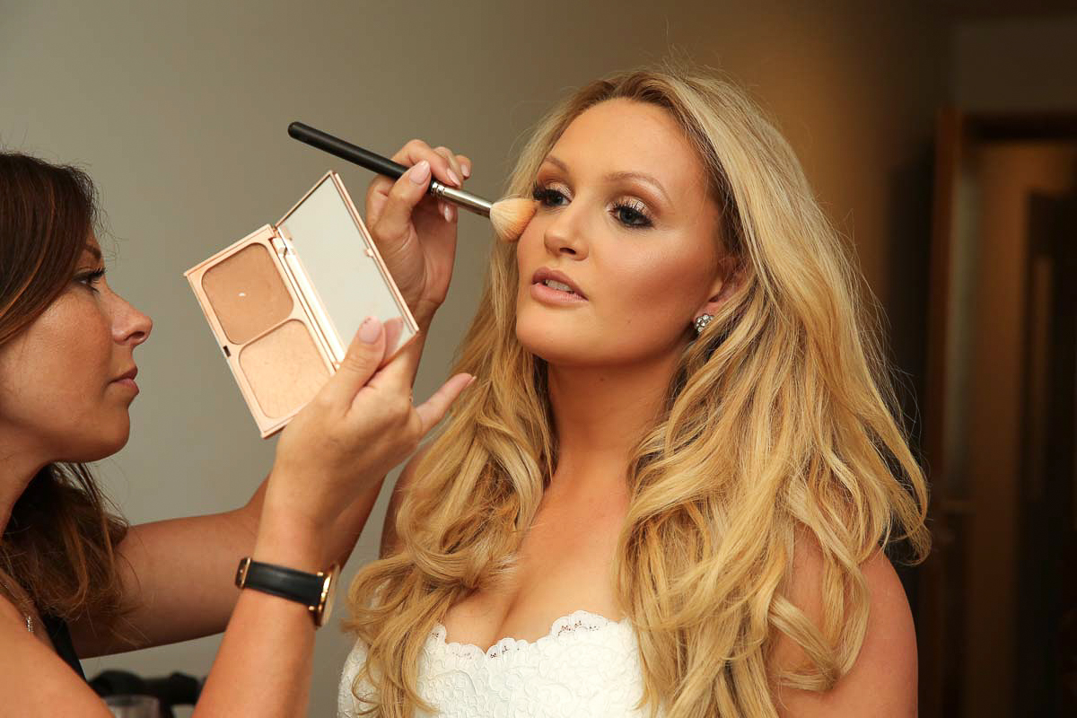 bride having her wedding makeup done