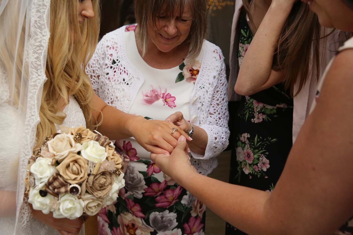 bride showing ladies her wedding ring