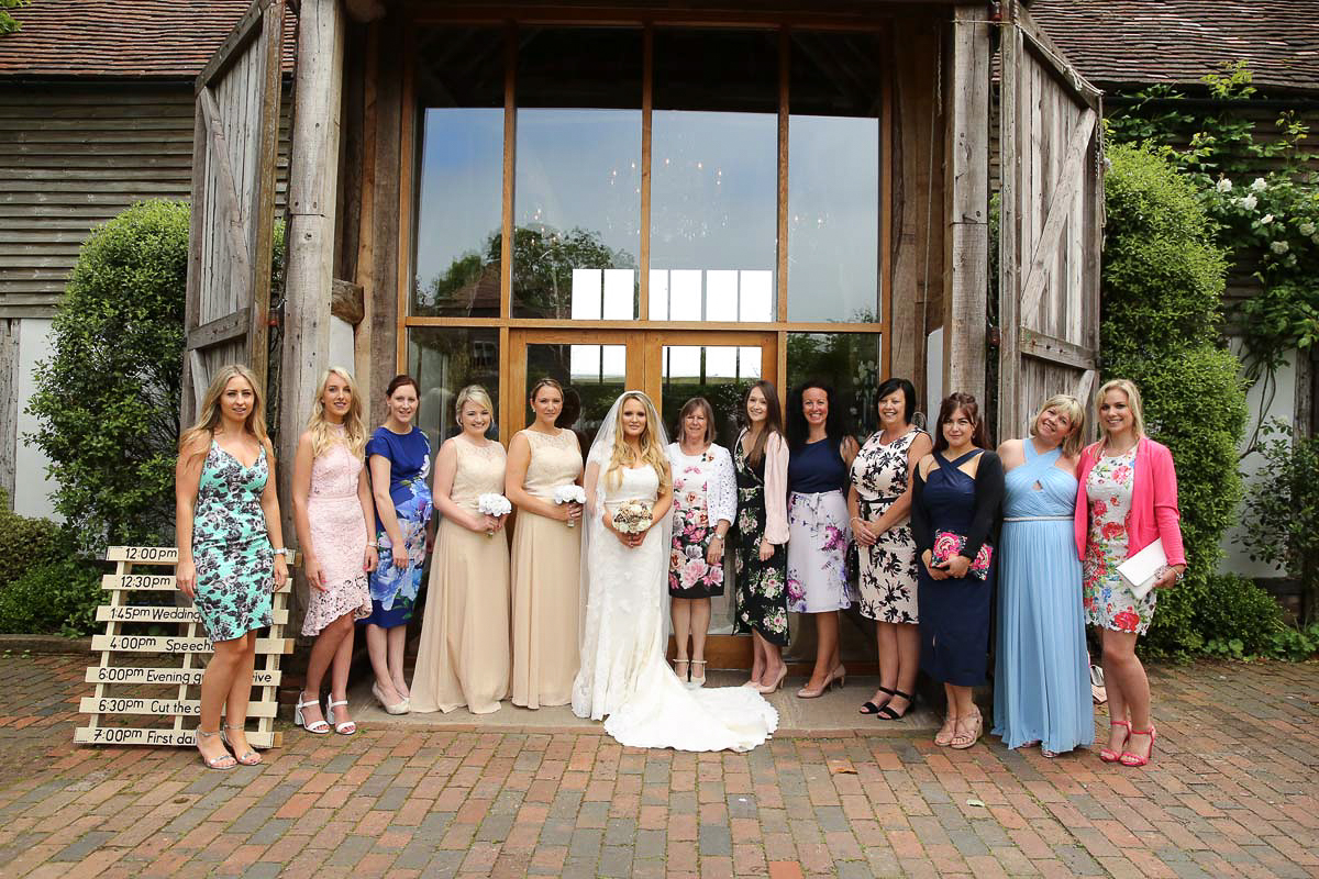 bride and female guests lined up for a photo