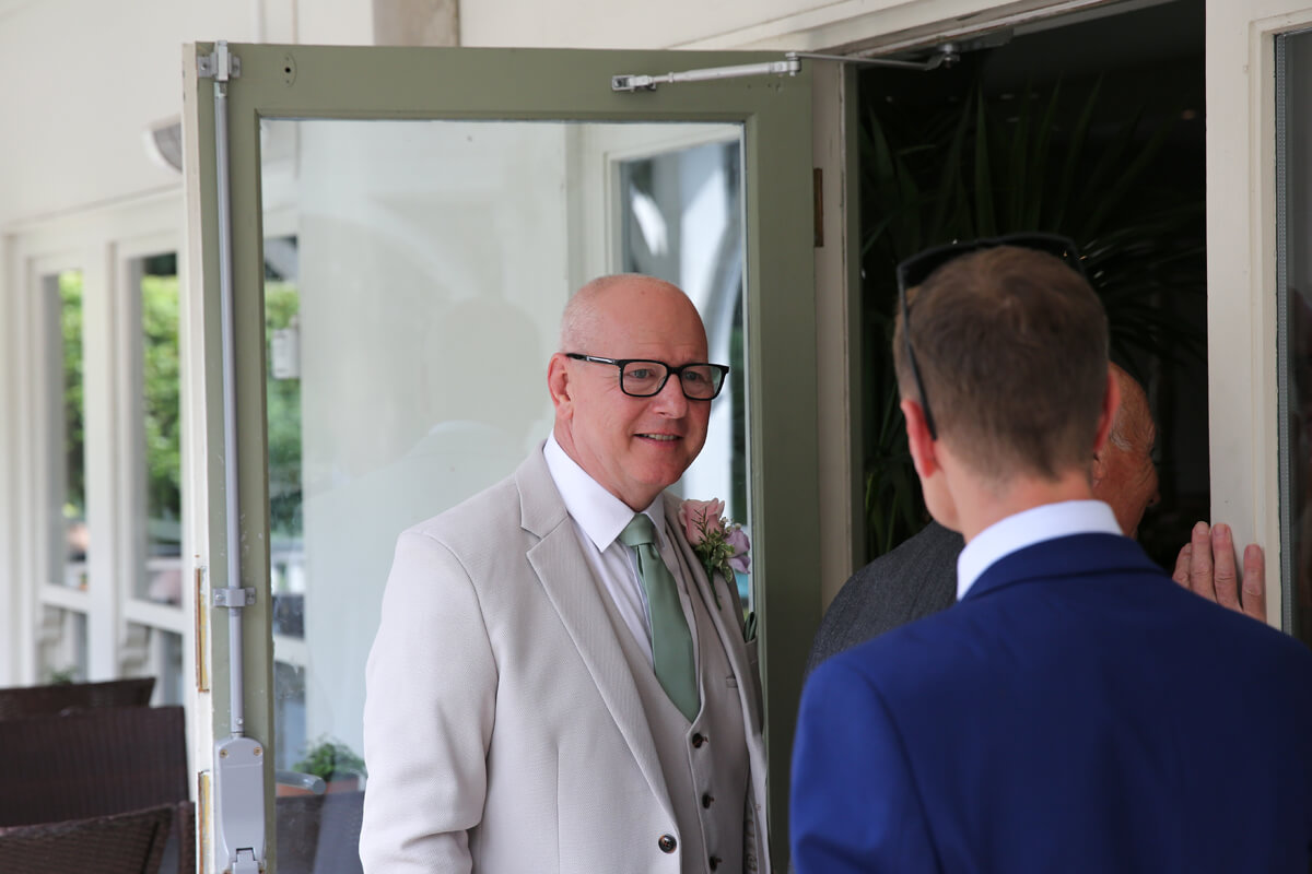 groom talking to a guest