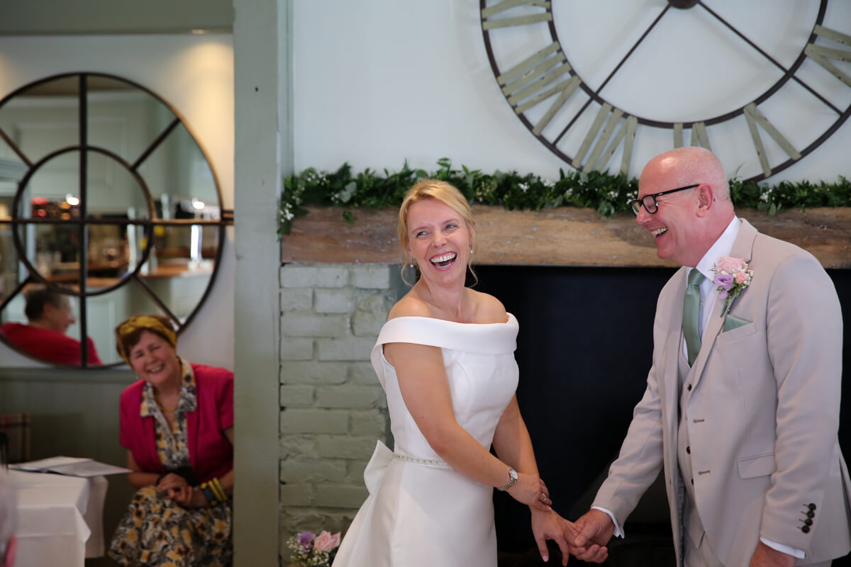 bride and groom laughing