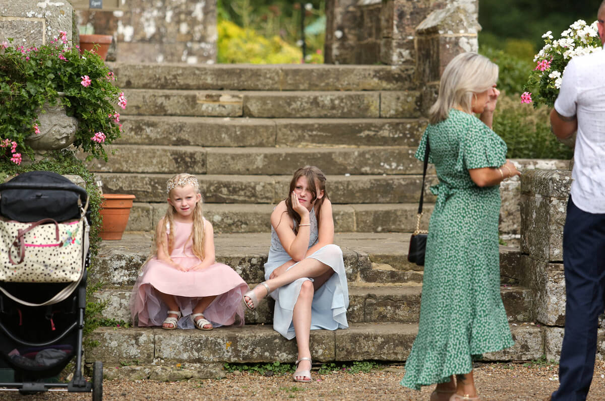 two girls sitting bored on the stairs Wadhurst Castle