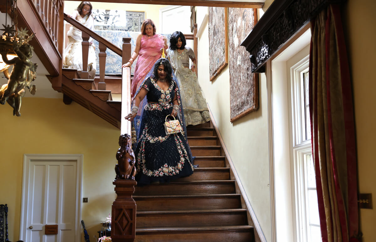 Indian wedding at Wadhurst Castle bride coming down the stairs