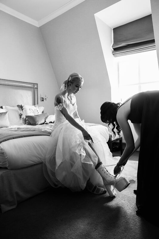 bride getting her boots put on