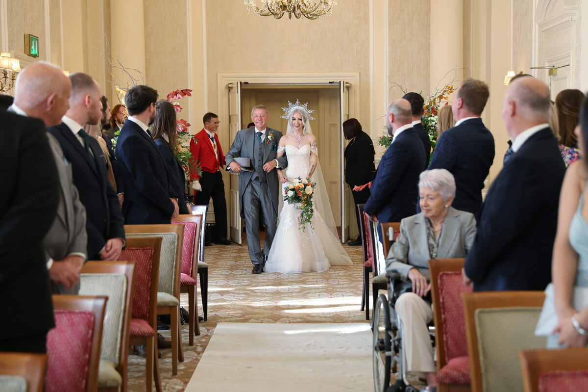 father of the bride walking her up the isle at The Grand Hotel Eastbourne