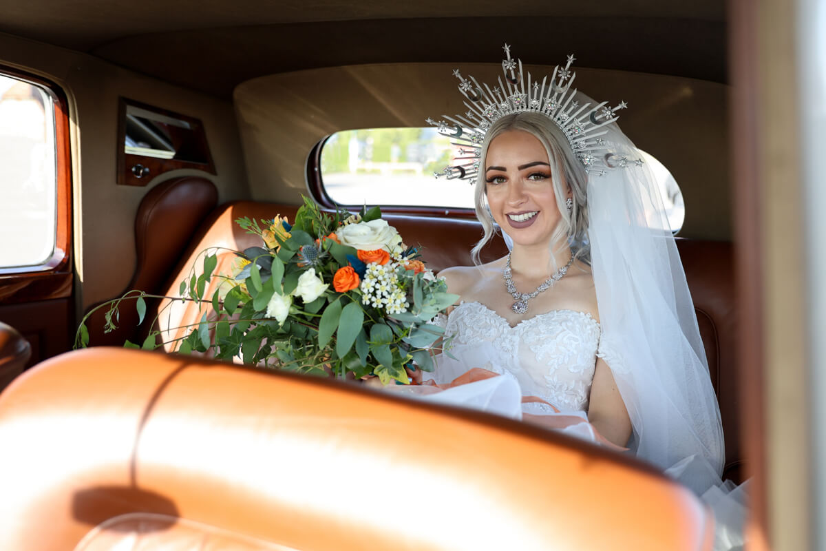 bride and groom inside a wedding car outside the Grand Hotel Eastbourne