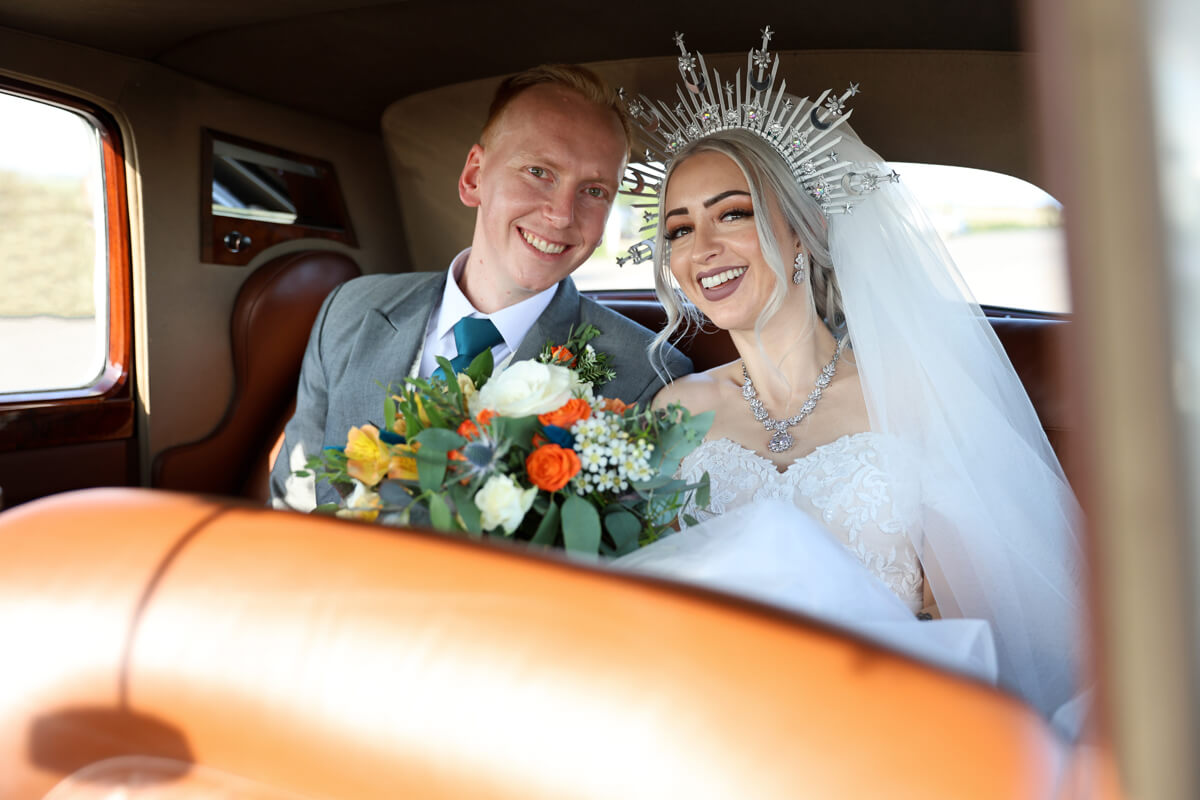 bride and groom inside a wedding car outside the Grand Hotel Eastbourne
