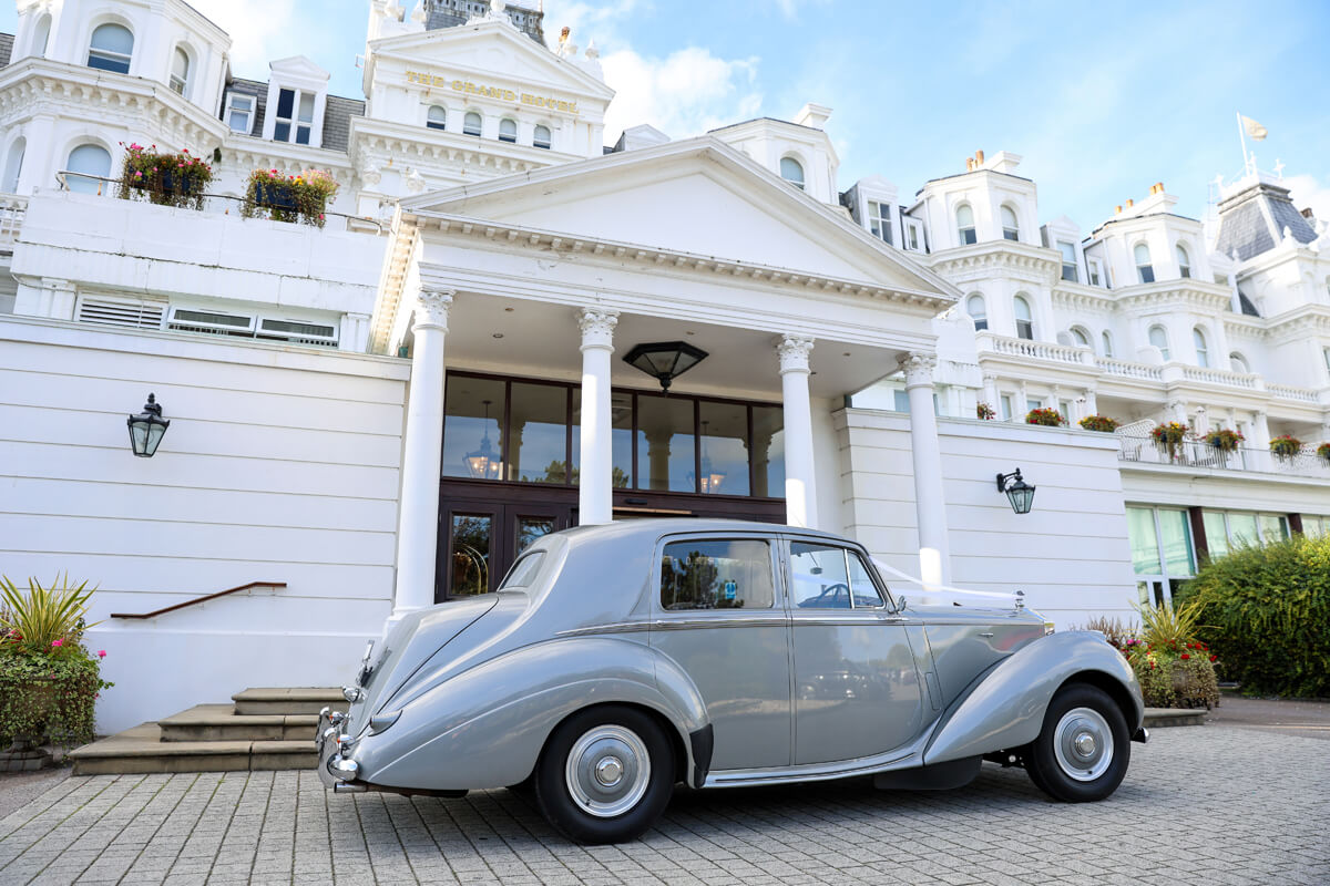 A wedding car parked outside The Grand Hotel Eastbourne