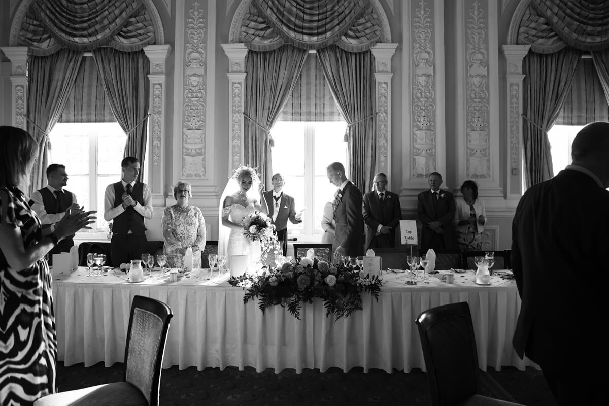 bride and groom sitting down to start the speeches at the grand hotel Eastbourne