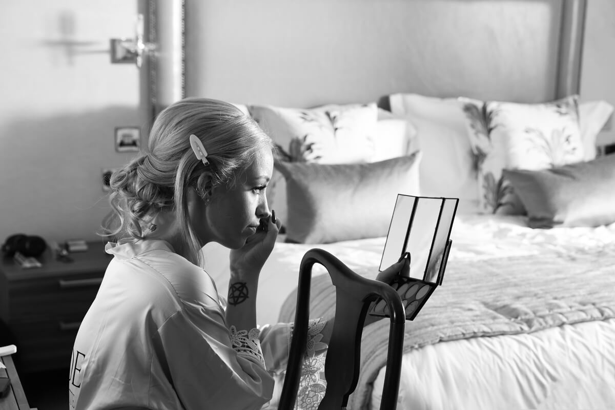 bride doing her makeup at The Grand Hotel Eastbourne