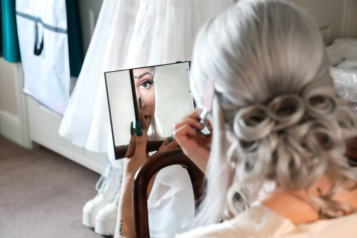 bride looking into a mirror at The Grand Hotel Eastbourne