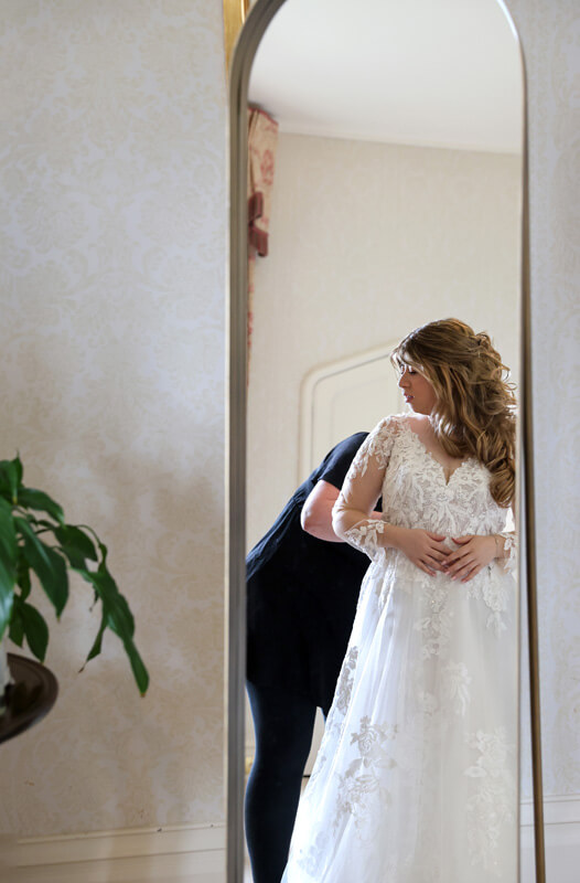 bride standing in front of a mirror