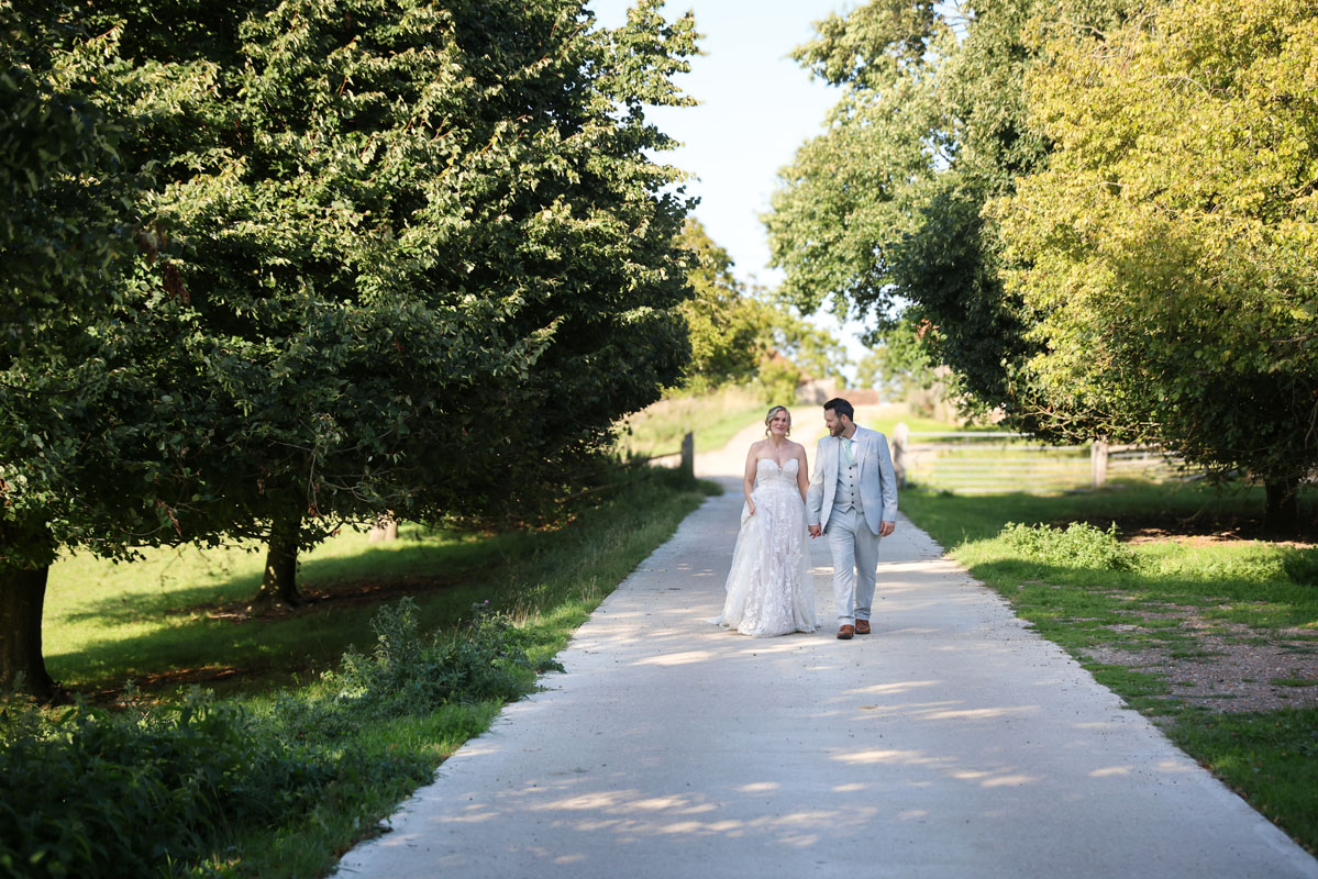 bride and groom walking holding hands